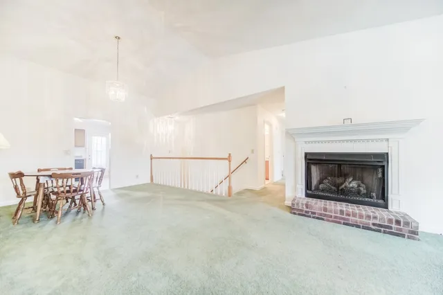 a living room with furniture a table and a fireplace