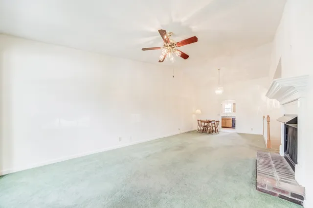 a view of a livingroom with furniture and a ceiling fan