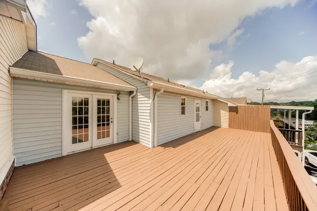 a view of a house with a wooden deck