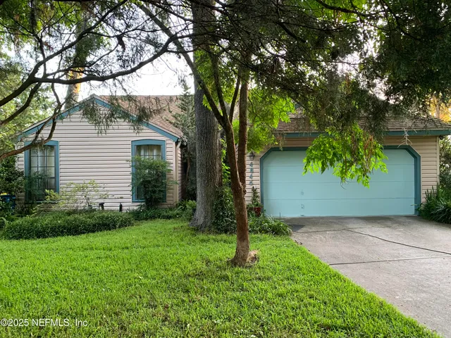 a view of a tree in front of a house