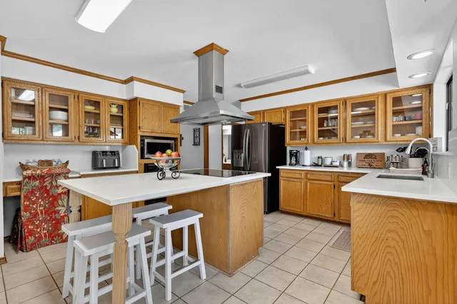 a large kitchen with a table and chairs