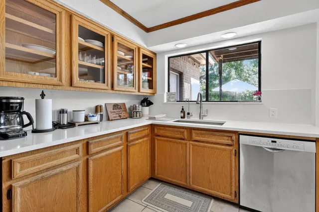 a kitchen with stainless steel appliances granite countertop a sink and cabinets