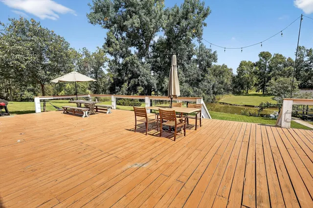 a view of a house with pool and sitting area