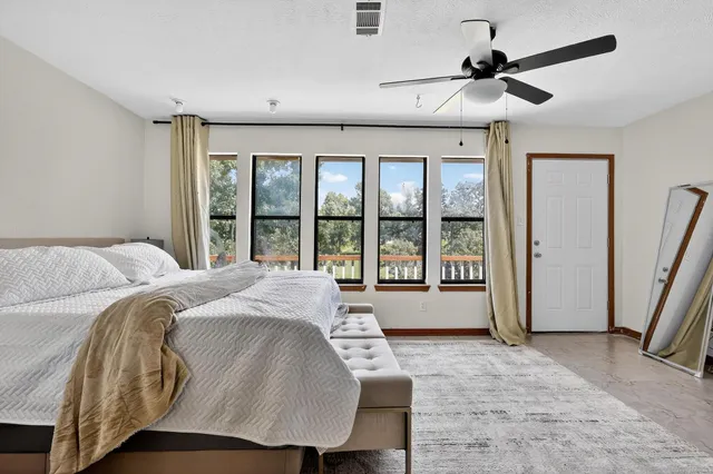 a view of a hallway with wooden floor and a bedroom