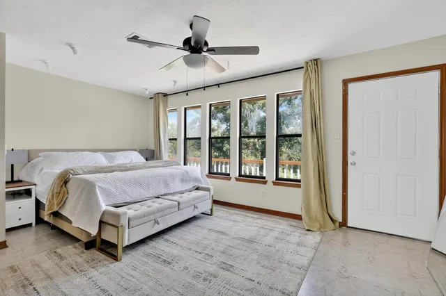 a spacious bedroom with a large bed and a large window