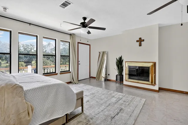 a spacious bedroom with a bed and a large window