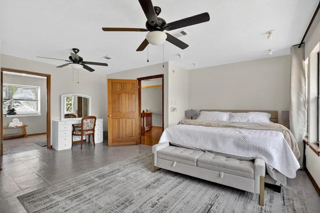 a spacious bedroom with a bed and a fireplace