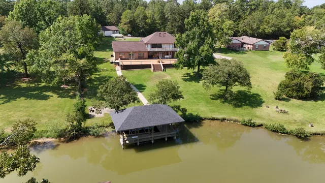 a swimming pool with outdoor seating and yard