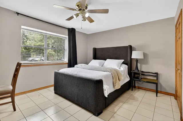 a bed room with a bed and a ceiling fan