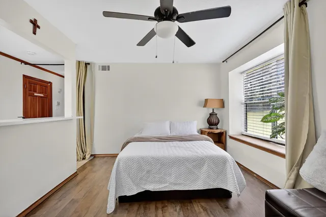 a bedroom with a bed and a window