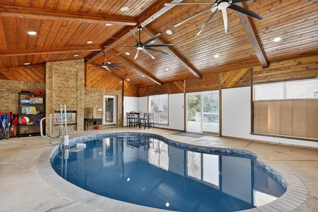 a dining hall with stainless steel appliances granite countertop lots of wooden furniture