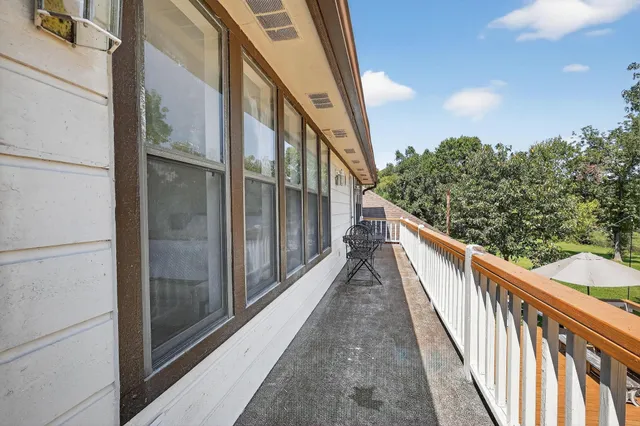 a kitchen with stainless steel appliances granite countertop a sink window and cabinets