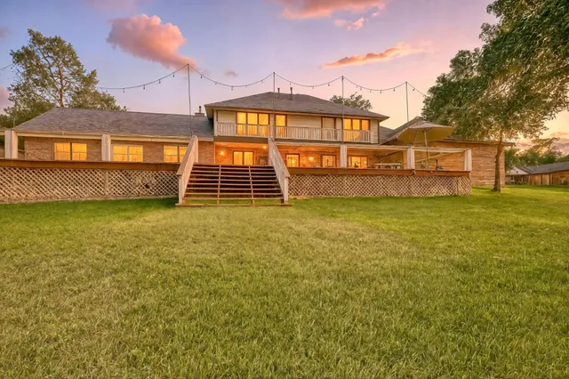 a view of a house with backyard porch and sitting area
