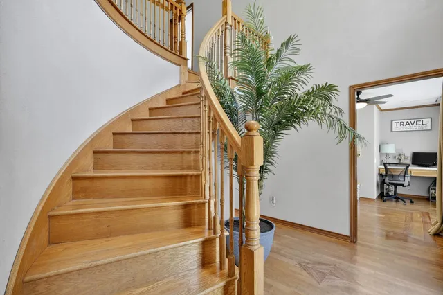 a view of entryway and hall with wooden floor