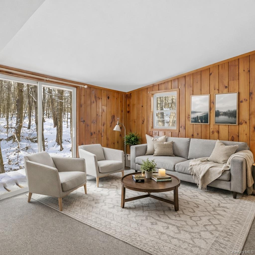 269 Oakland Valley Road Cuddebackville, NY 12729 - Photo 9 of 22 Virtually staged living room with sliding doors to side porch overlooking the creek