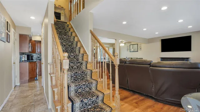 a living room with furniture a fireplace and a flat screen tv