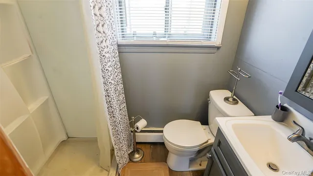 a bedroom with a bed and dresser with mirror