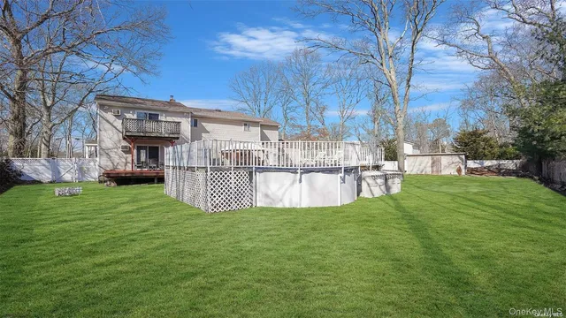 a view of a patio with couches chairs and wooden floor