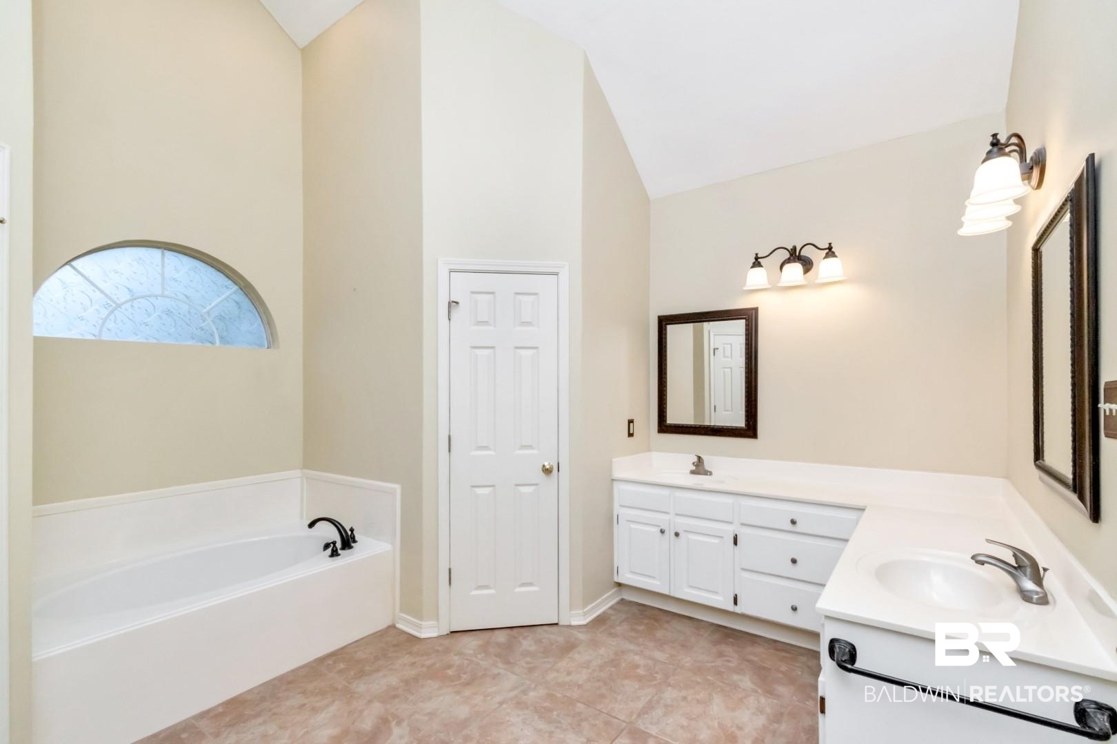 152 Ideal Avenue Mobile, AL 36608 - Photo 22 of 32 Bathroom featuring a washtub, vanity, vaulted ceiling, and tile patterned flooring