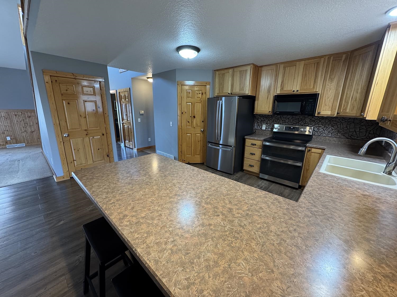 7876 Hickory Grove Road Savanna, IL 61074 - Photo 15 of 67 a kitchen with stainless steel appliances granite countertop a refrigerator a stove top oven a sink and dishwasher