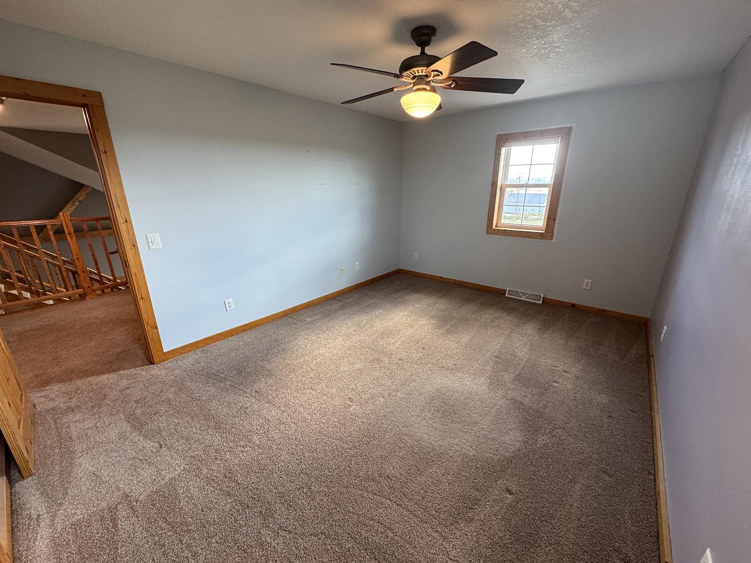 7876 Hickory Grove Road Savanna, IL 61074 - Photo 41 of 67 an empty room with windows and ceiling fan