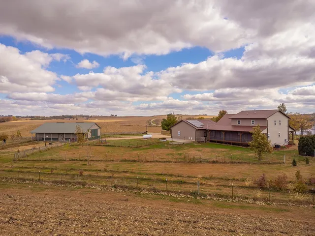 a view of a house with swimming pool and a yard
