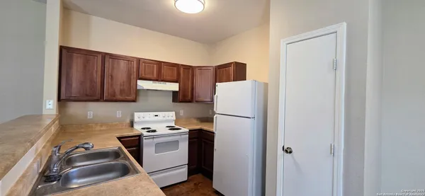 a kitchen with a refrigerator sink and stove