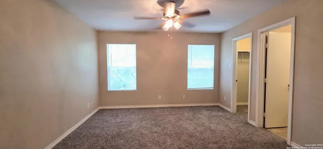 a view of room with window and ceiling fan