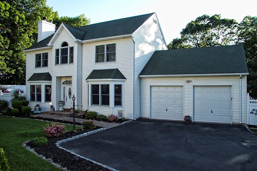 26 Franklin Road Sound Beach, NY 11789 - Photo 1 of 1 View of front facade featuring a garage and a front yard
