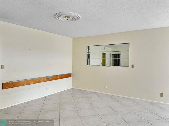 a view of an empty room with glass door