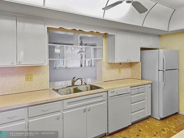 an empty room with large windows and yard