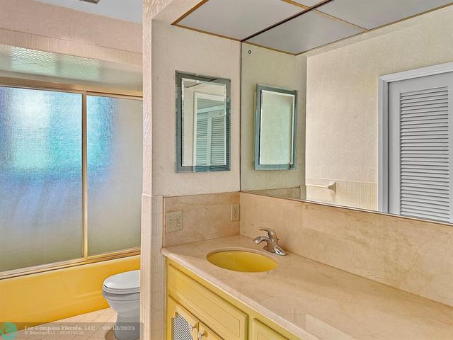 a kitchen with granite countertop cabinets stainless steel appliances and a counter space