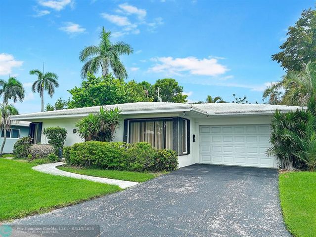 a view of a room with a door and a window
