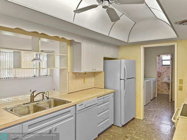 a living room with furniture a dining table and a flat screen tv