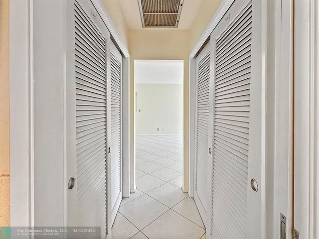 a view of a house with a patio and a garden