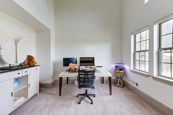 a view of a workspace with furniture and a window