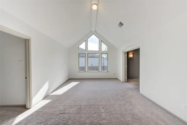 an empty room with windows and closet