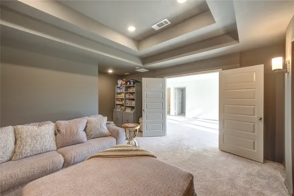 a living room with furniture and a ceiling fan