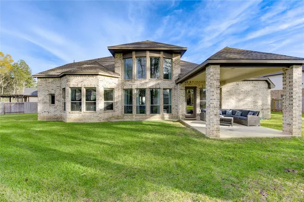 a view of a house with a backyard