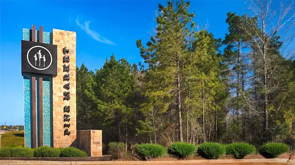 a front view of a house with a tree