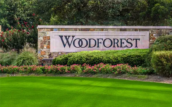 a sign that is in front of flowers