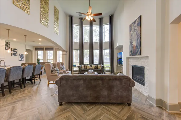 a living room with fireplace furniture and a chandelier