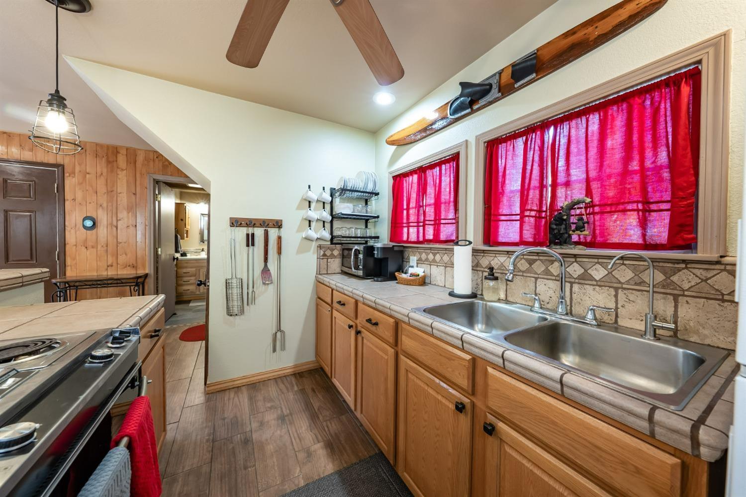 41534 Indian Rock Road Shaver Lake, CA 93664 - Photo 11 of 19 a kitchen with a sink a counter top space stainless steel appliances and a window
