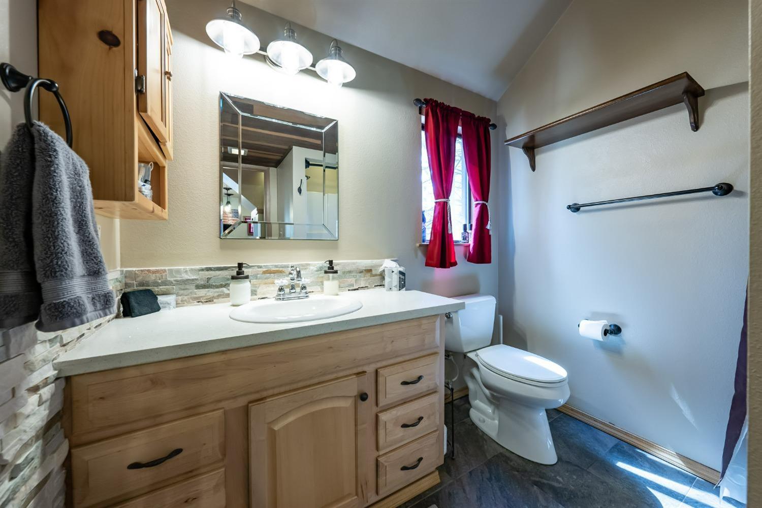 41534 Indian Rock Road Shaver Lake, CA 93664 - Photo 13 of 19 a bathroom with a sink and a mirror
