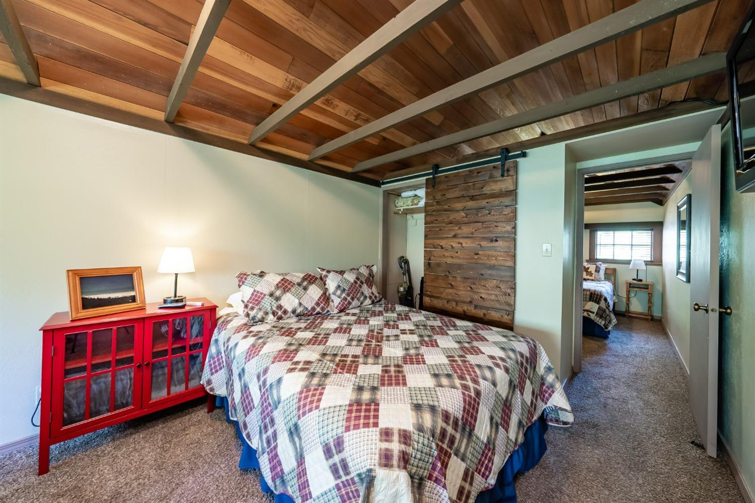 41534 Indian Rock Road Shaver Lake, CA 93664 - Photo 15 of 19 a bed sitting in a bedroom next to a window