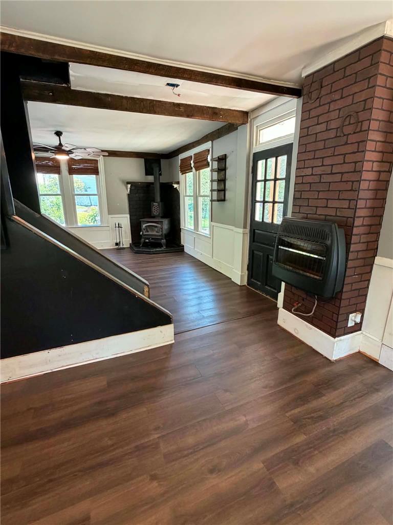 164 Sand Spring Road Cresco, PA 18326 - Photo 35 of 60 A welcoming interior features rich wood flooring, exposed beam ceilings, and a charming wood-burning stove.