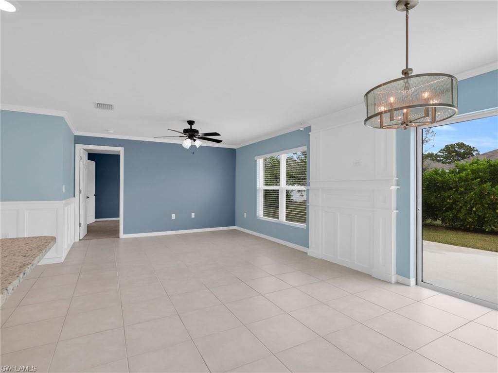 731 Hadley Place West Naples, FL 34104 - Photo 18 of 30 Great Room and Dining Area With Crown Molding, Tile Flooring, Custom Woodwork Wall Featurre, and Faux Wood Blinds