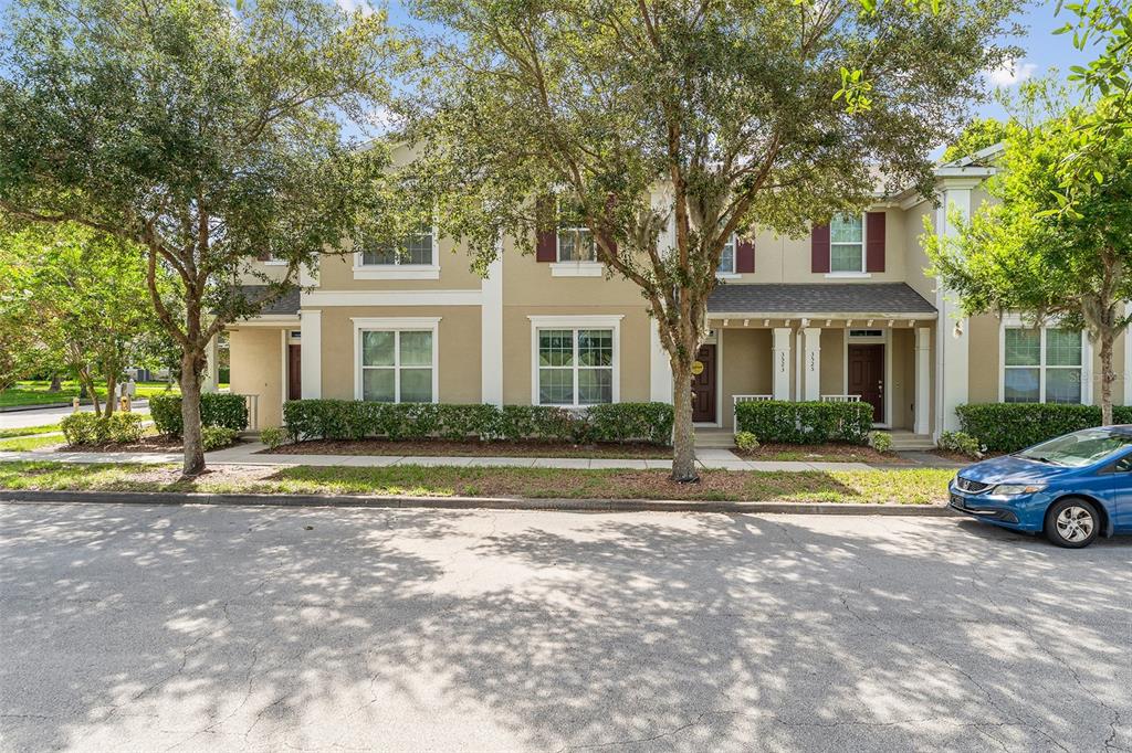 3523 Clay Brick Road St. Cloud, FL 34773 - Photo 28 of 62 a front view of a house with a garden and trees