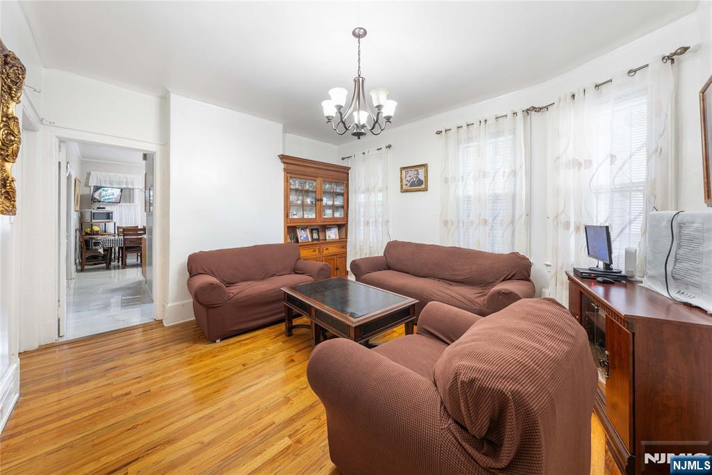58 Park Paterson, NJ 07501 - Photo 13 of 36 a living room with furniture and a chandelier