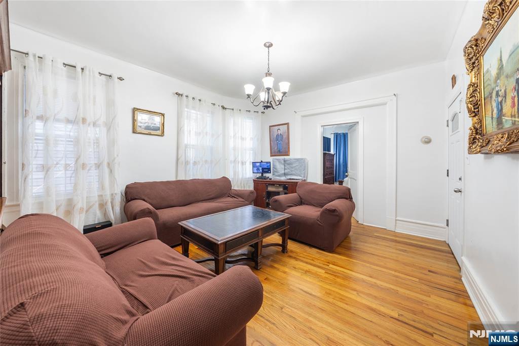 58 Park Paterson, NJ 07501 - Photo 14 of 36 a living room with furniture a chandelier and a window
